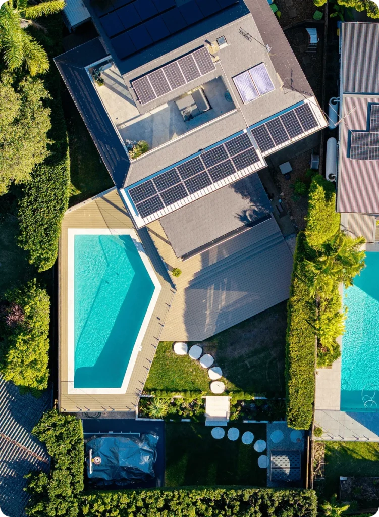 NF Build aerial drone view of residential property with solar panels, swimming pool, and outdoor deck