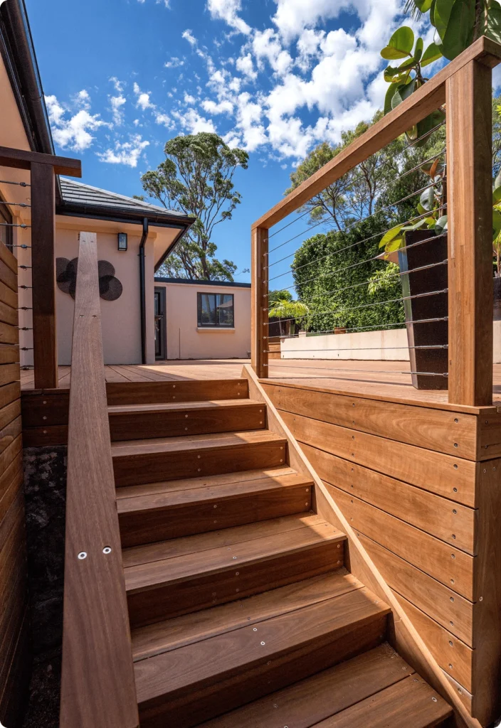 NF Build outdoor timber staircase leading to elevated deck with wire balustrade