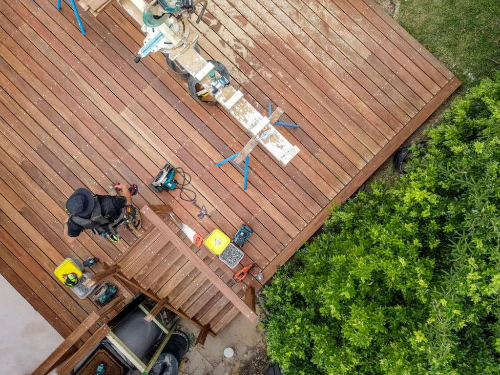 Aerial view of builder constructing outdoor timber deck for NF Build site project