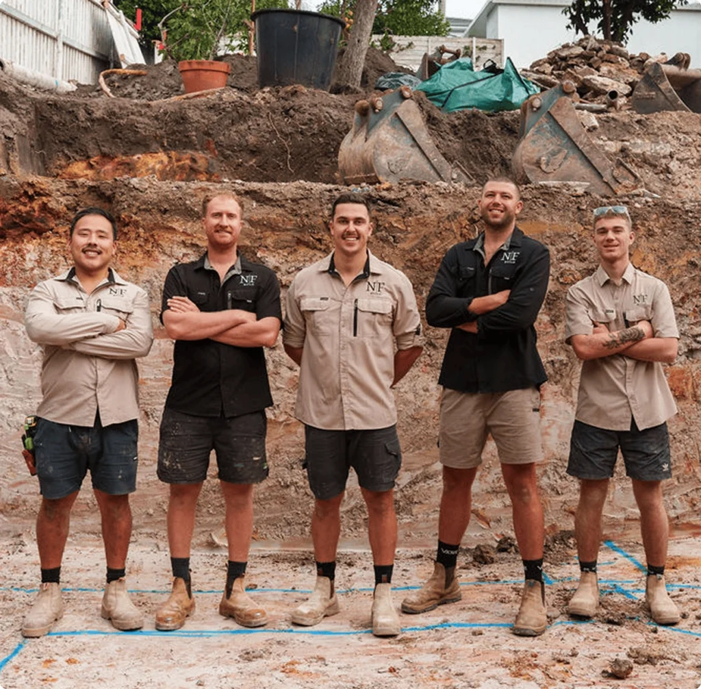 NF Build construction team standing together on a renovation job site