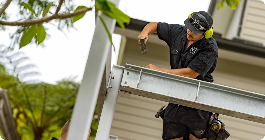 NF Build builder installing steel beam during home extension construction